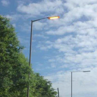 Street light on during the daytime