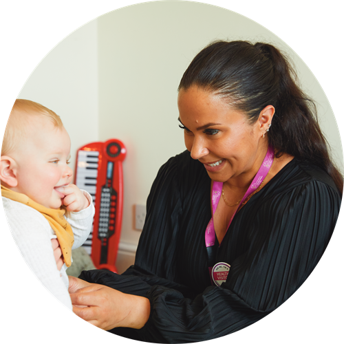 Health visitor checking a baby