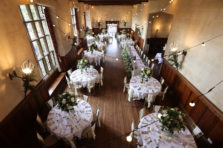 Candlelit tables in a large, light hall