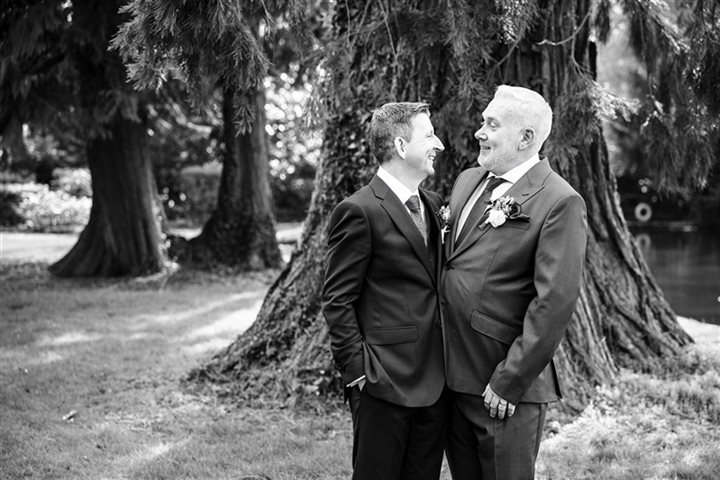 Black and white image of two men smiling