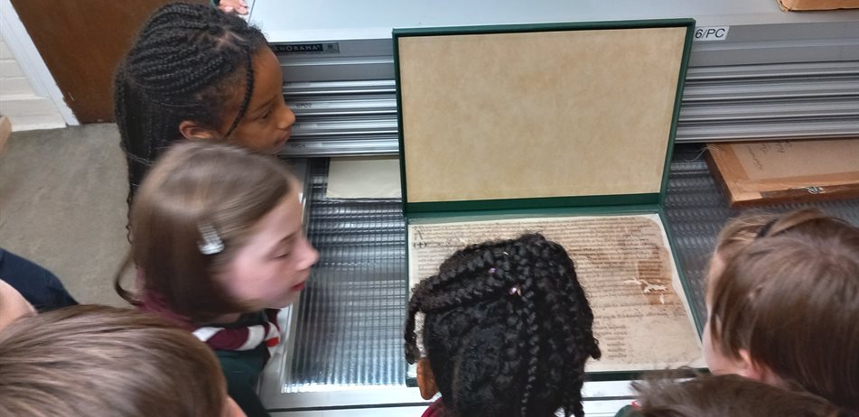 Children looking at a historical document