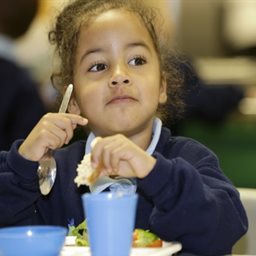 Child enjoying a school meal