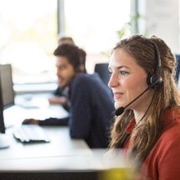 A woman wearing a headset in a call centre